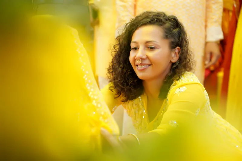 Candid laughter during the floral/turmeric shower