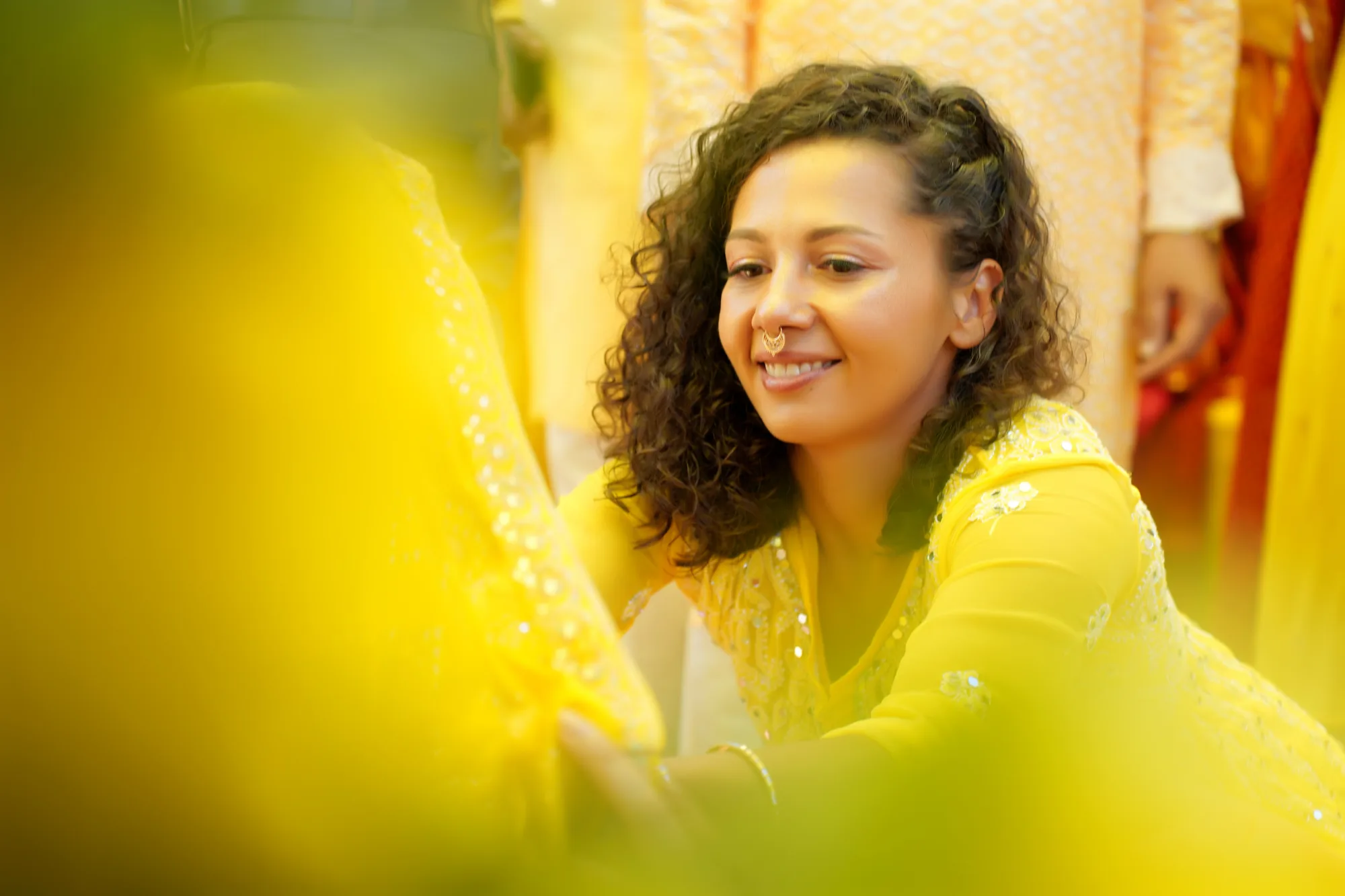 Candid laughter during the floral/turmeric shower